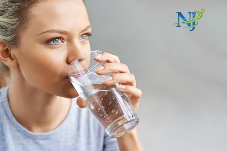 woman drinking water while following nutrition counseling in new jersey