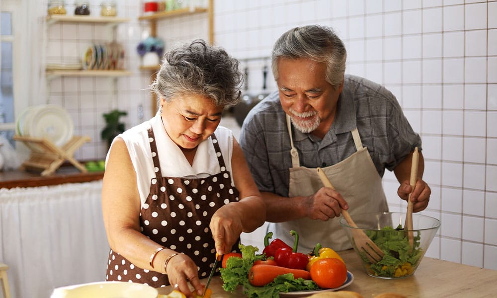 couple in NJ cooking a healthy meal to help prevent a hernia