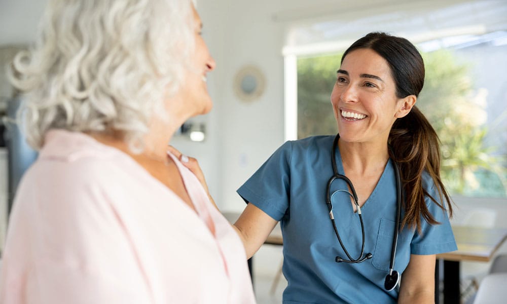 woman speaking with her doctor after her excess skin removal surgery in NJ