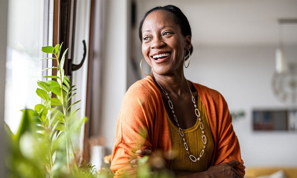 woman in NJ smiling after her excess skin removal surgery