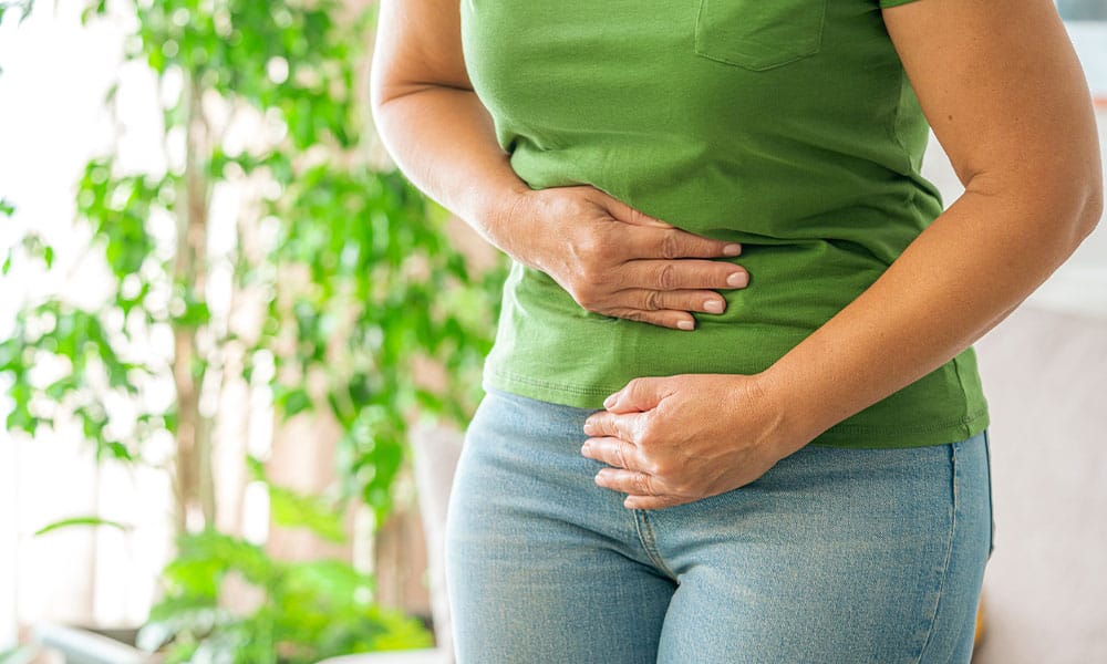 woman in New Jersey feeling pain from her inguinal hernia