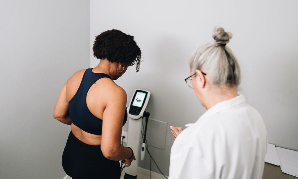 doctor in New Jersey weighing her patient