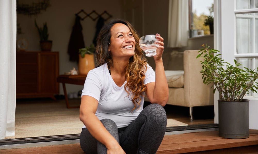woman drinking water after her gallbladder removal in New Jersey