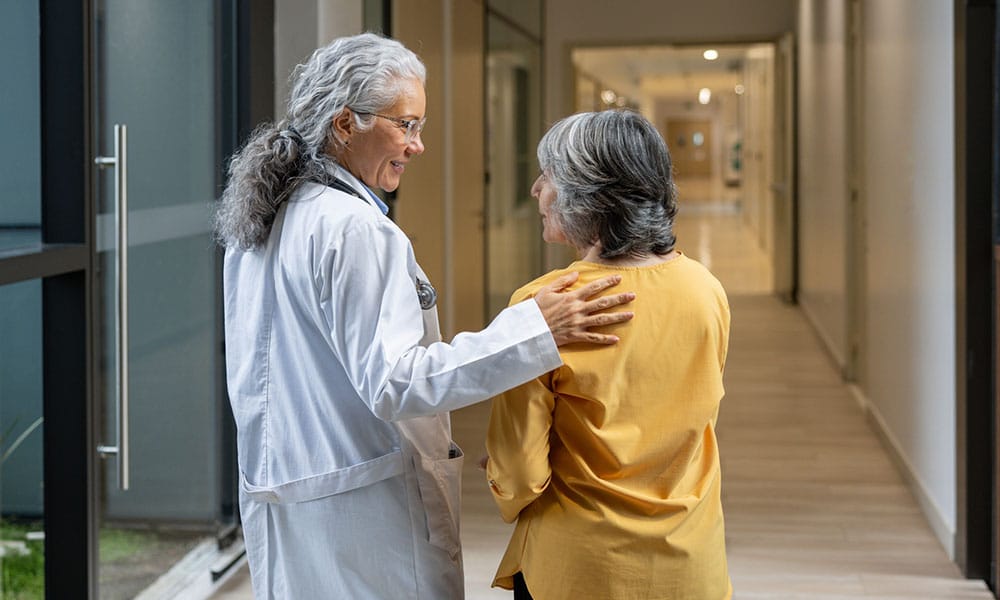 woman speaking with her doctor after her acid reflux surgery in New Jersey