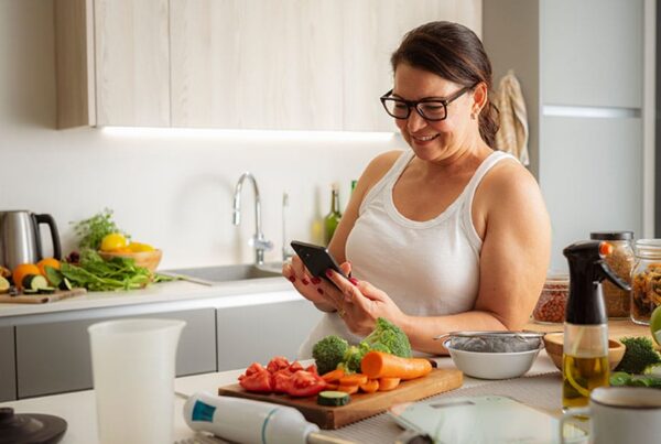 woman cooking after meeting with a nutritionist for weight loss in New Jersey