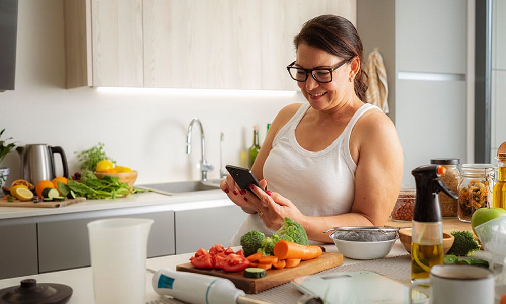 woman cooking after meeting with a nutritionist for weight loss in New Jersey