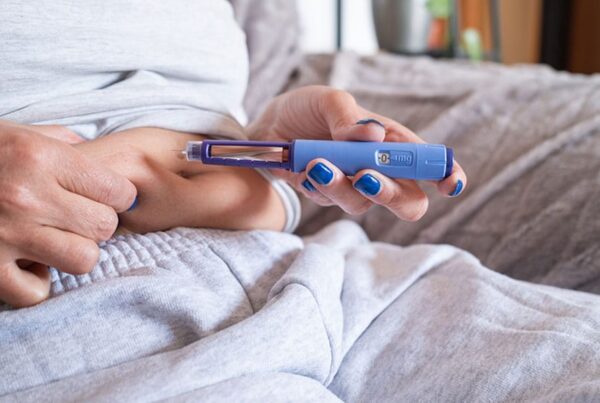 woman taking her glp-1 shot in New Jersey