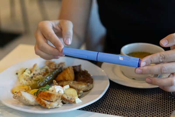 man taking a glp-1 before eating a healthy meal