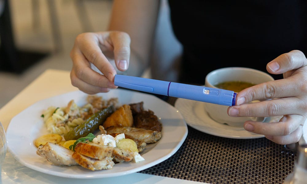 man taking a glp-1 before eating a healthy meal