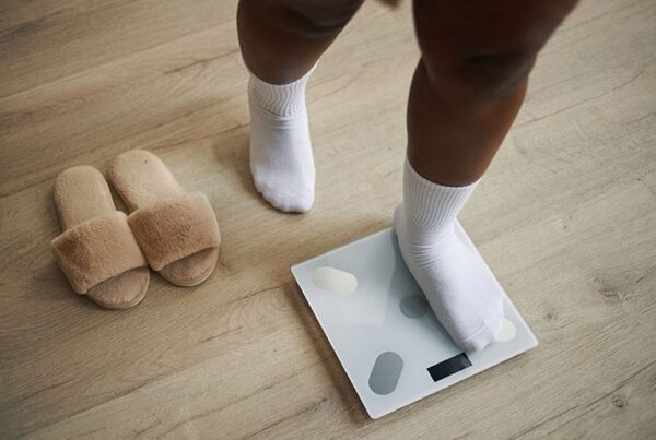 person in New Jersey on a scale regaining weight after bariatric surgery