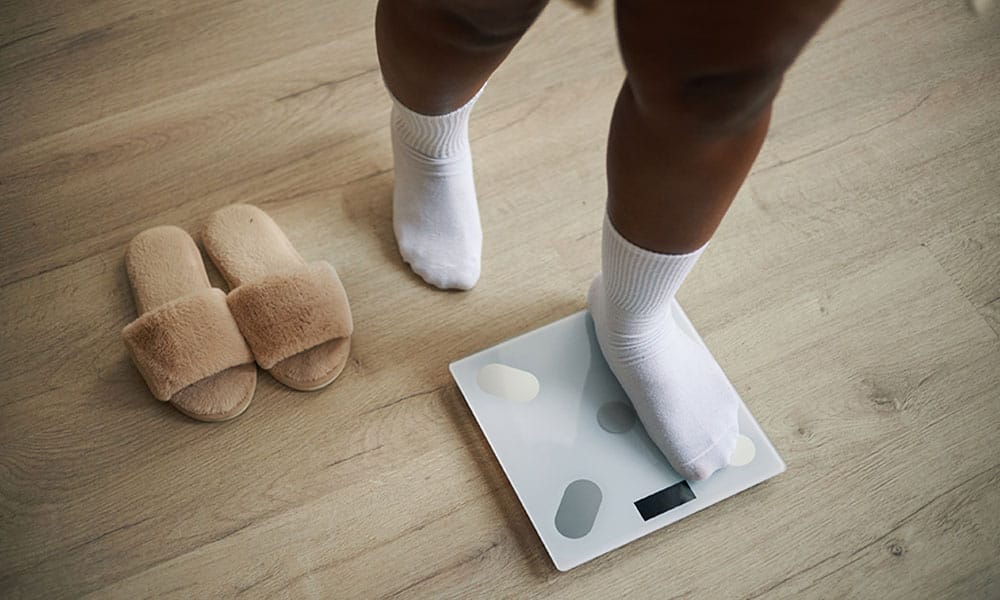 person in New Jersey on a scale regaining weight after bariatric surgery